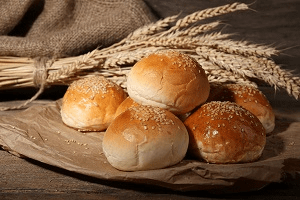 A pile of bread roles on a table